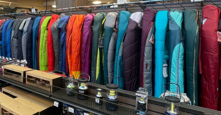 a variety of sleeping bags at a scheels store