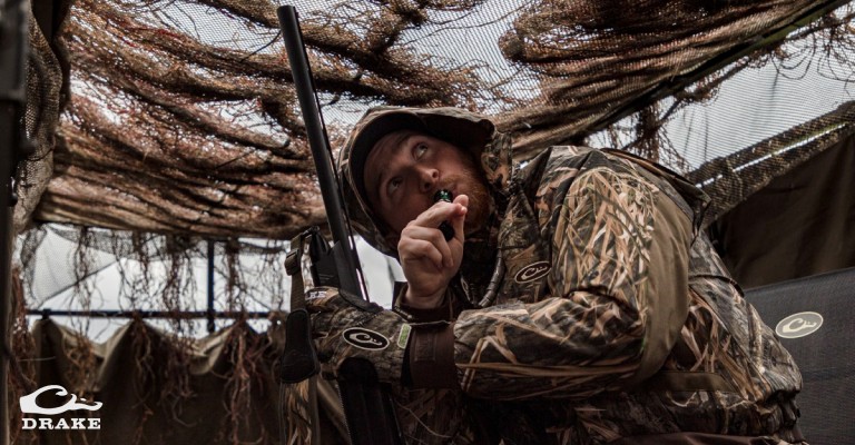 duck hunter sitting in A-frame duck blind