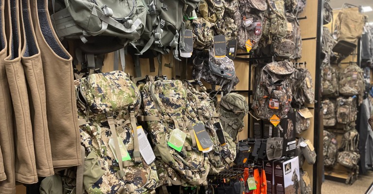 a wall of hunting packs at eau claire scheels