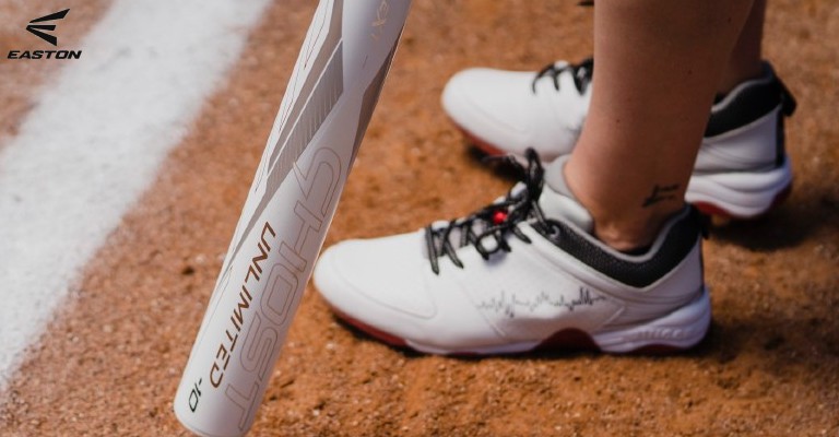 a woman wearing softball cleats at homepage