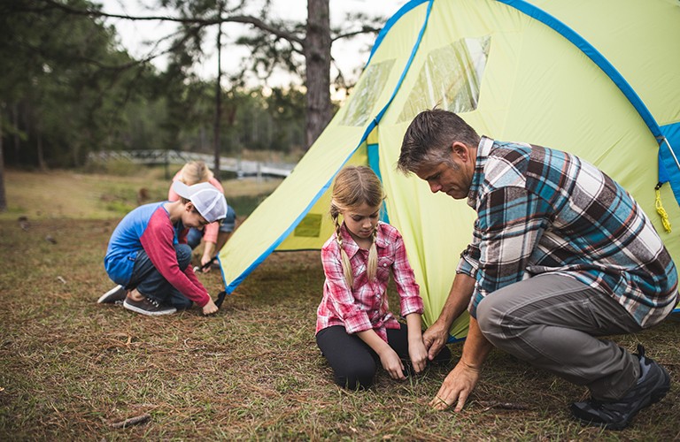 A family pitching a tent