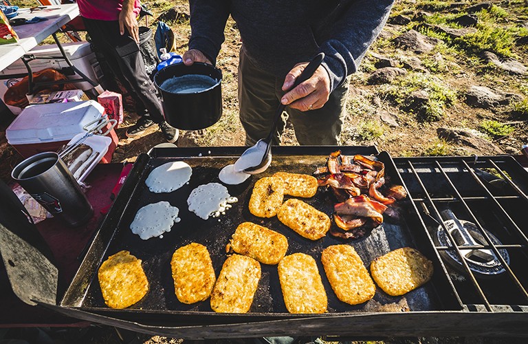 Cooking breakfast on a camping griddle