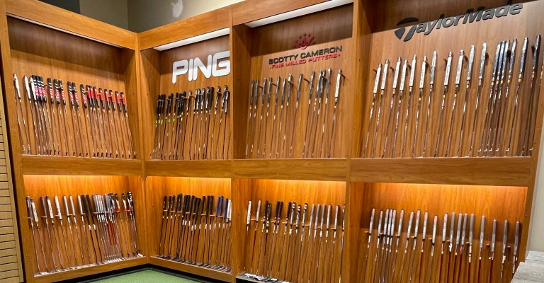 a wall of golf putters at fargo scheels