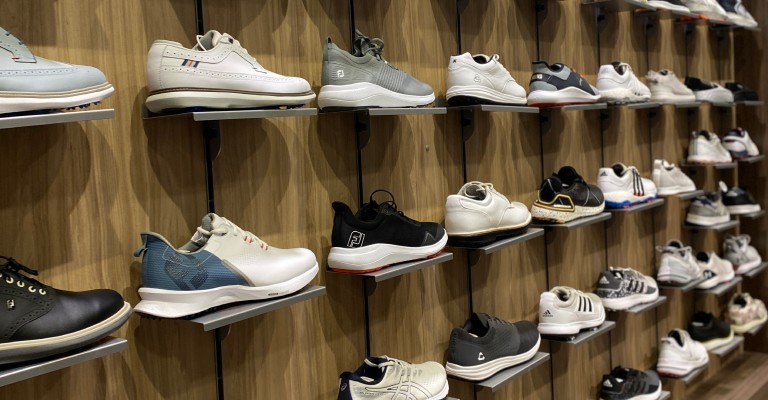 a wall of golf shoes at fargo scheels