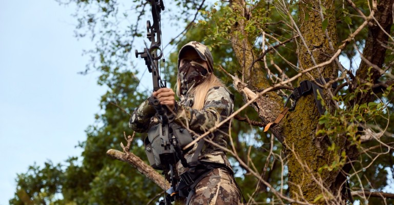 female hunting in a tree stand