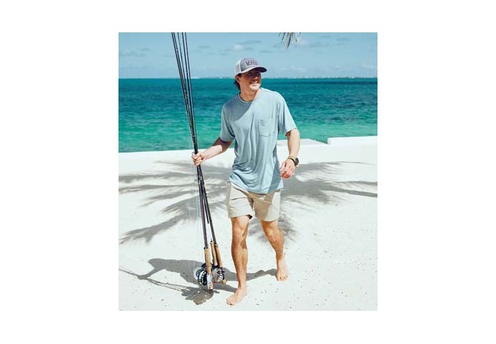 A Man carrying his fishing rods, about to go fishing