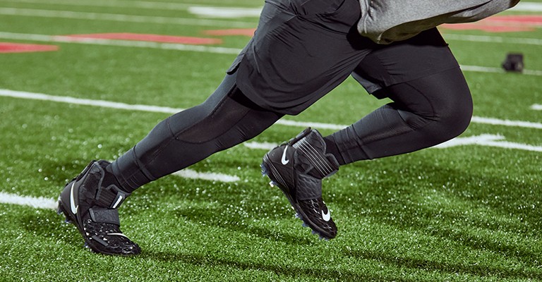 football player running in Nike football cleats