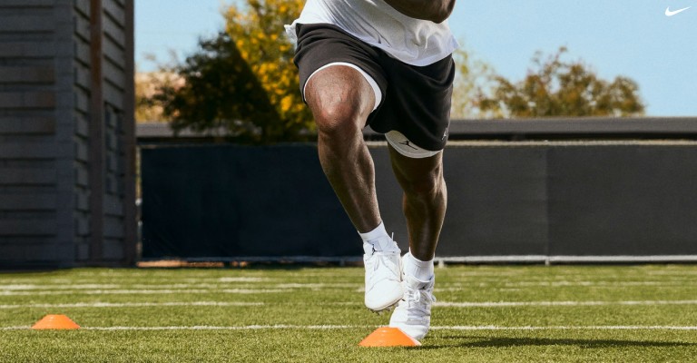 a football player practicing in football cleats