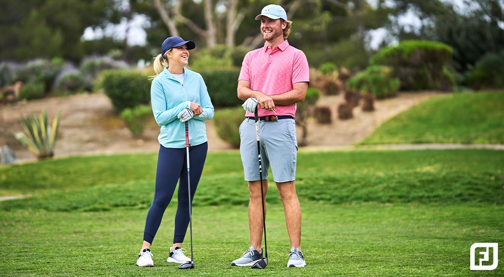 a female and male golfer on the golf course