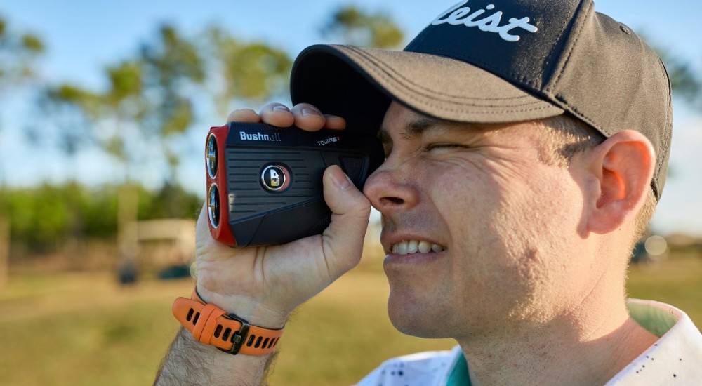 a man holding a golf rangefinder