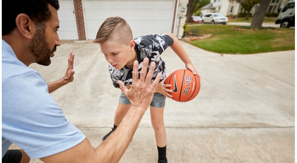 a family playing basketball