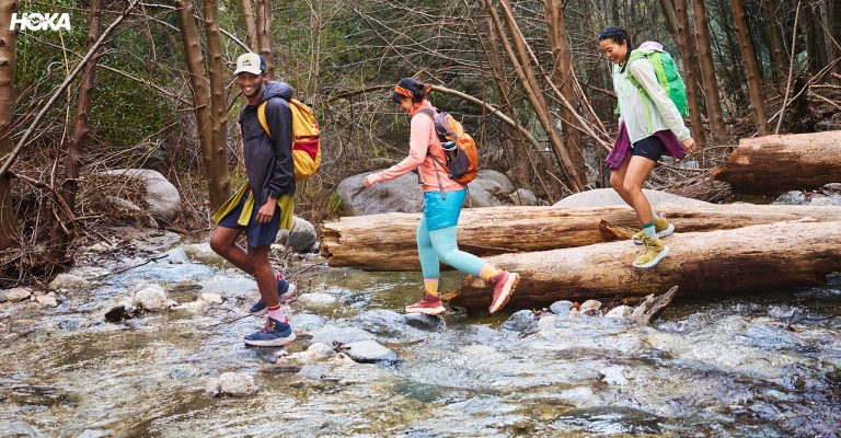 three people out hiking in hoka hiking boots