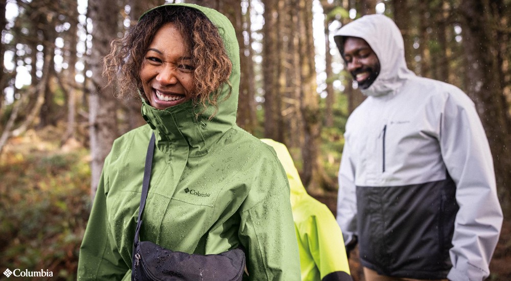 a family hoodieing columbia rain jackets on a hike