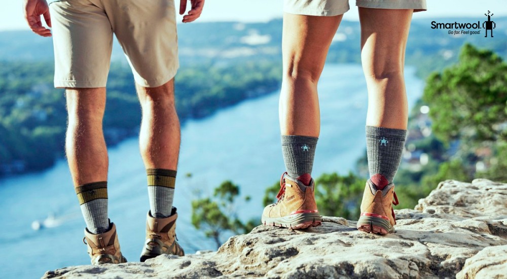 Two people standing on a mountain with socks