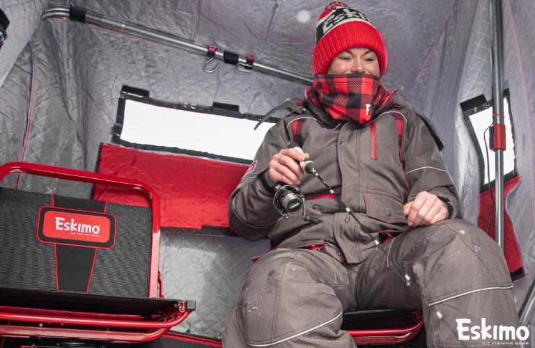 Ice fishing in a two angler flip over shelter