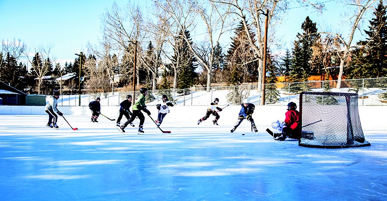 people playing hockey outdoors
