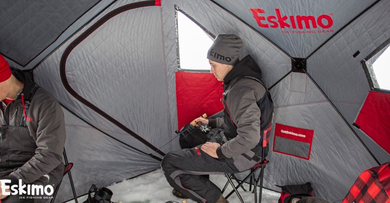 Ice fishing with a group in an Eskimo hub ice shelter