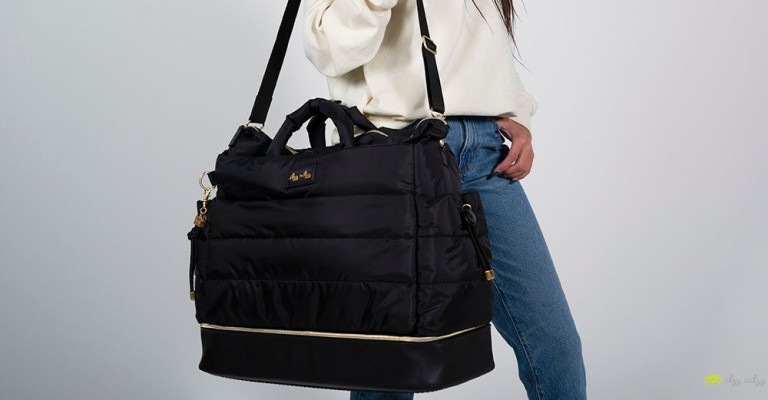 new mom holding luxury diaper bag from itzy ritzy