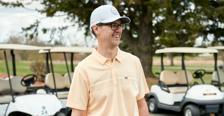 male golfer in proper golf attire