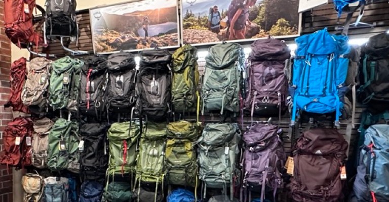backpacking packs on a wall at a scheels store