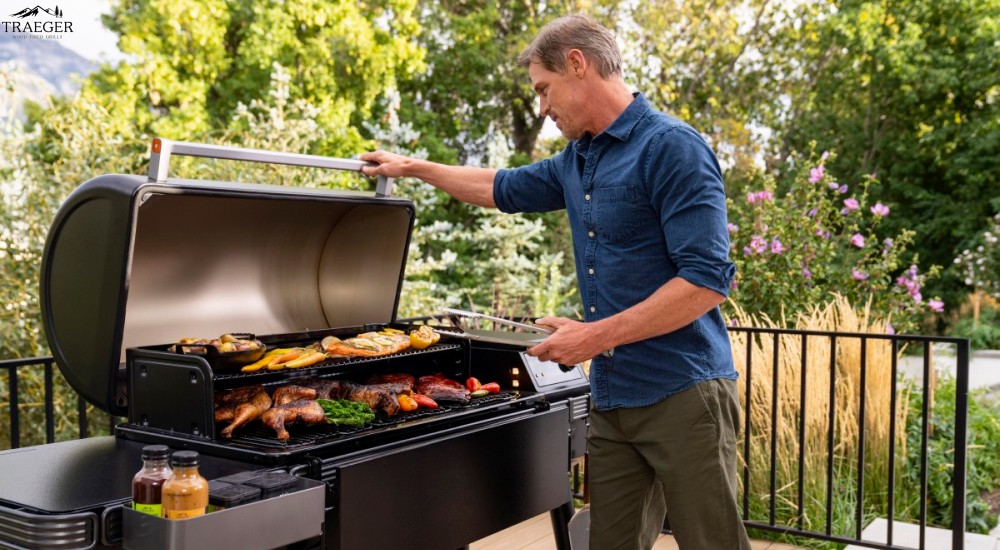 a man using his traeger grill 