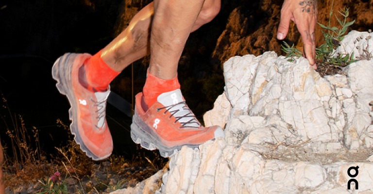 a runner wearing on cloudventure running shoes on the trail