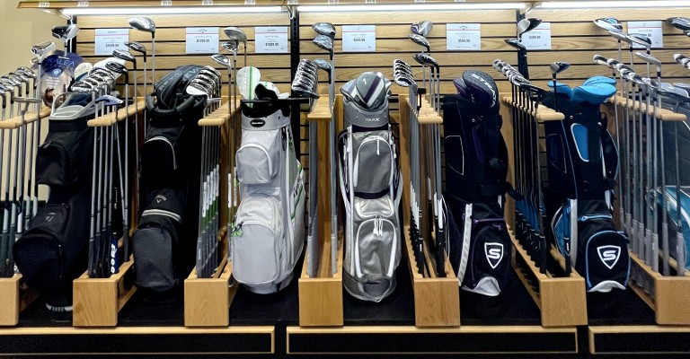 a display of golf clubs at a scheels golf shop