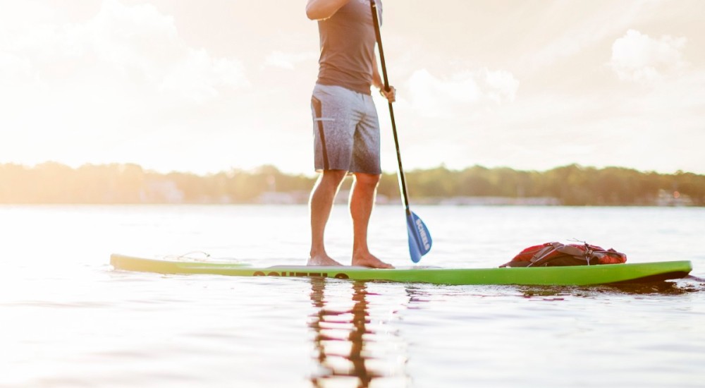 a man paddle boarding with his essential items with him