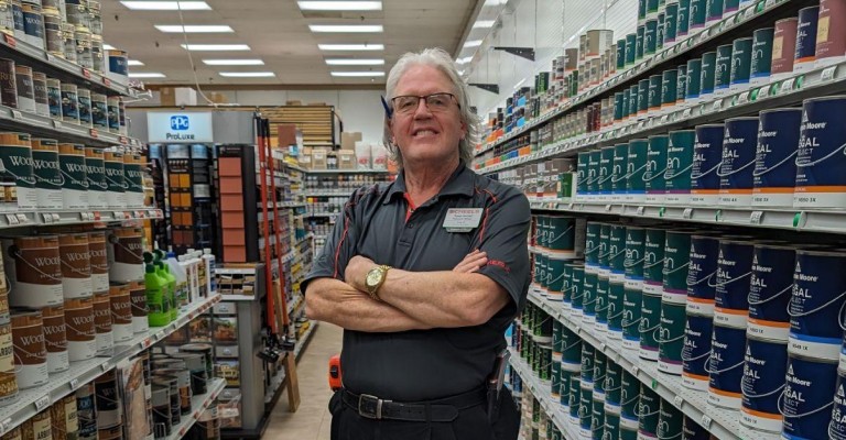 an associate at home and hardware in the paint aisle