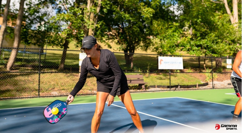 woman playing pickleball outside