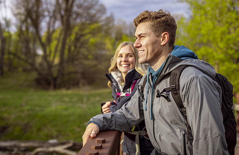 man and woman wearing rain del jackets 