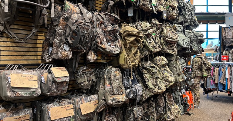 a wall of hunting packs at rapid city scheels hunting shop