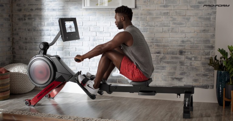 a man using a rowing machine at home