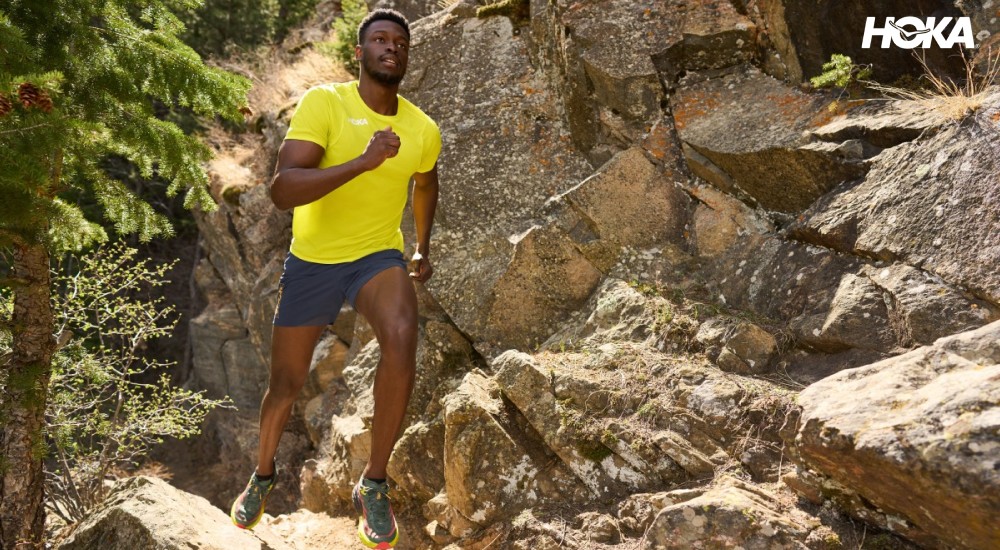 a man running on rocky trail terrain