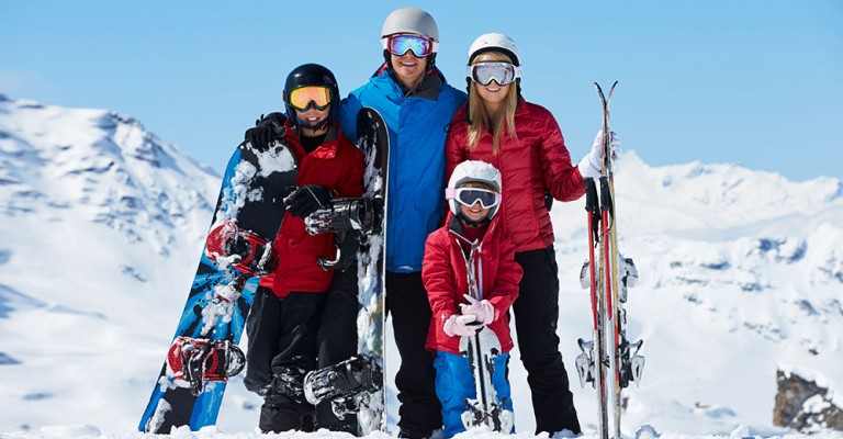 a family going skiing and snowboarding on the slopes