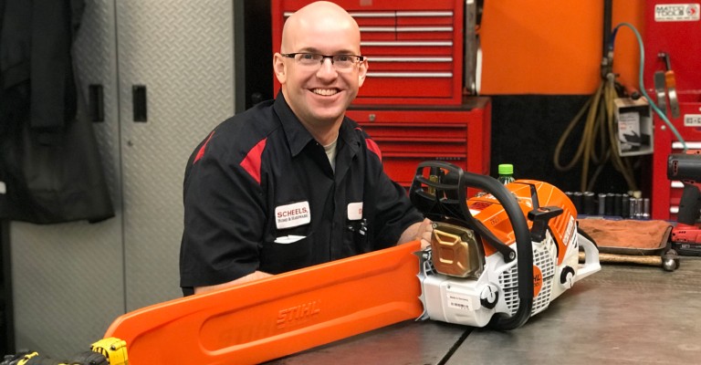 A Home & Hardware service technician repairing a chainsaw