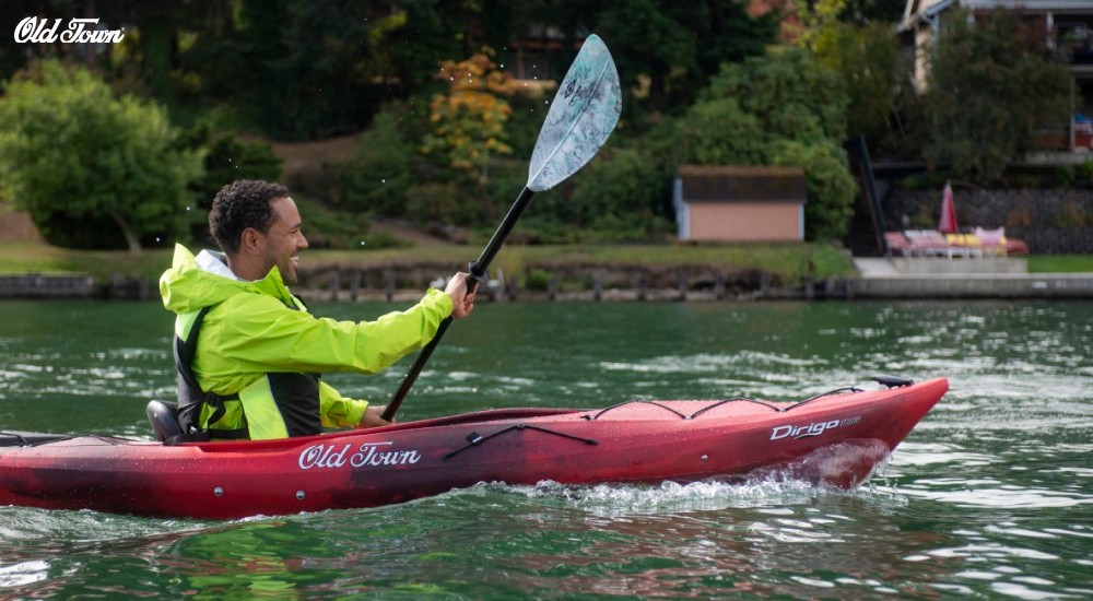 a man in a sit in kayak paddling 
