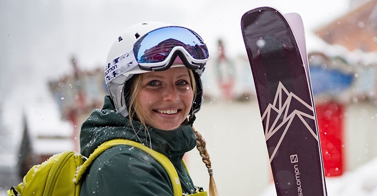 girl holding downhill skis