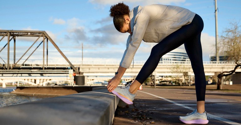 a woman stretching after running