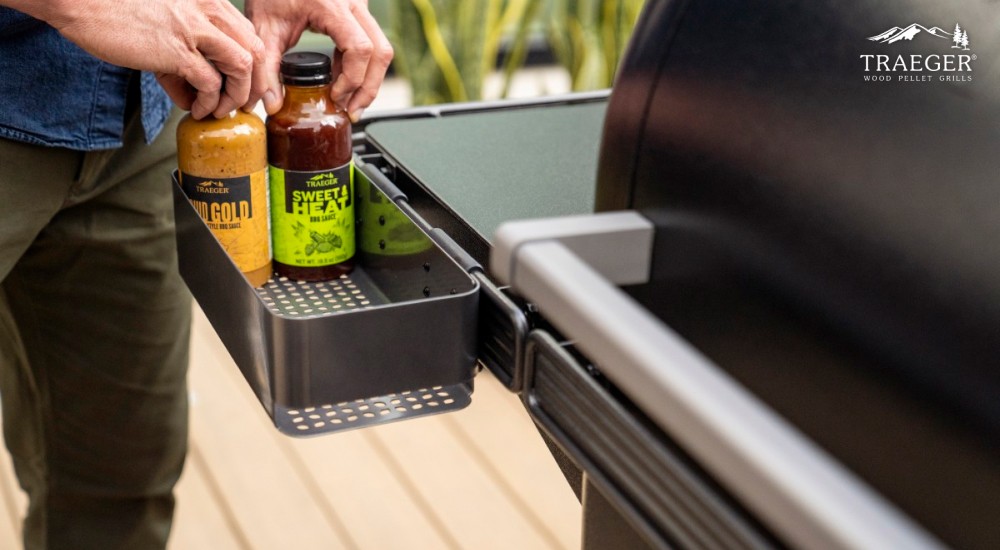 two traeger sauces in a shelf on the grill