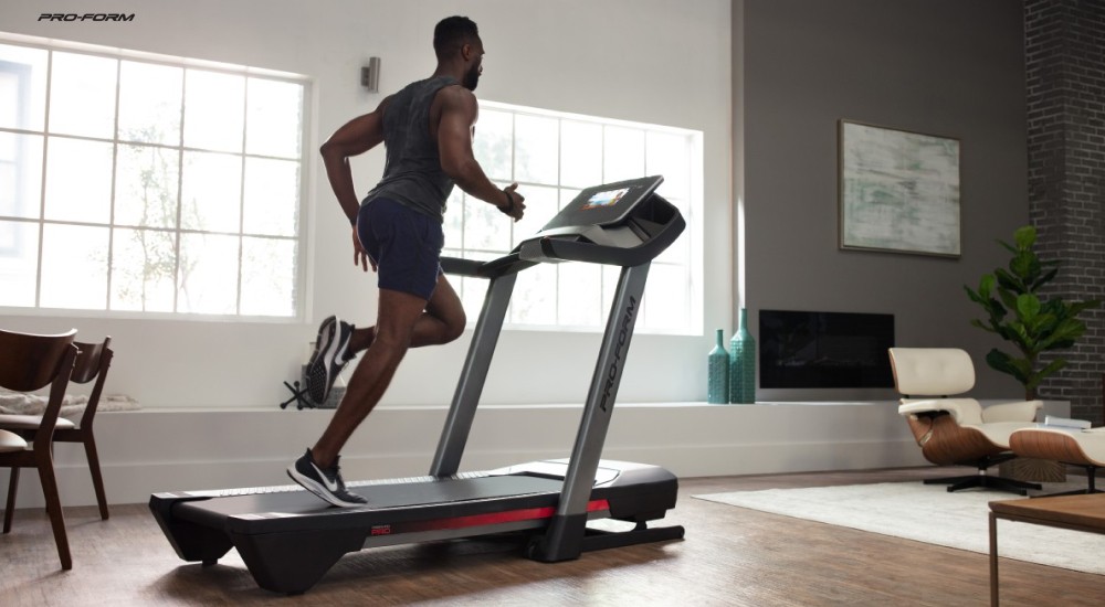 a man running on a treadmill at home