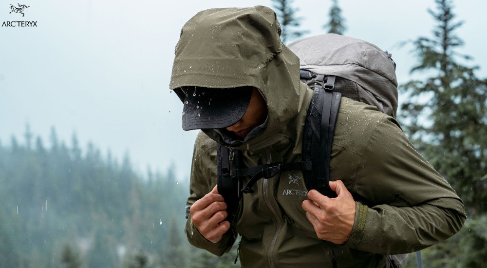 a man wearing a rain jacket while hiking