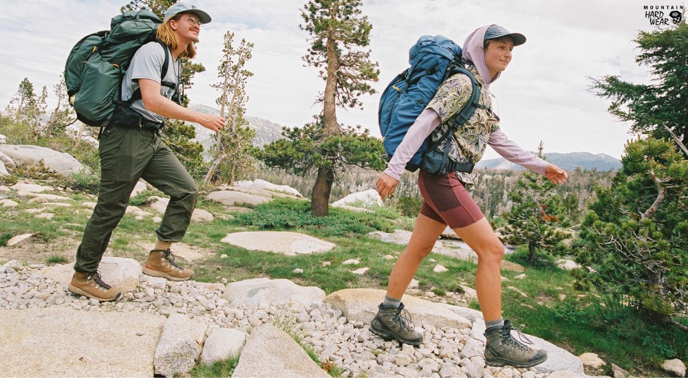two hikers out on the trails wearing hiking clothing