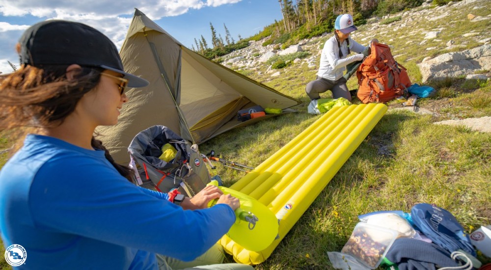 A group of people setting up camp after hiking