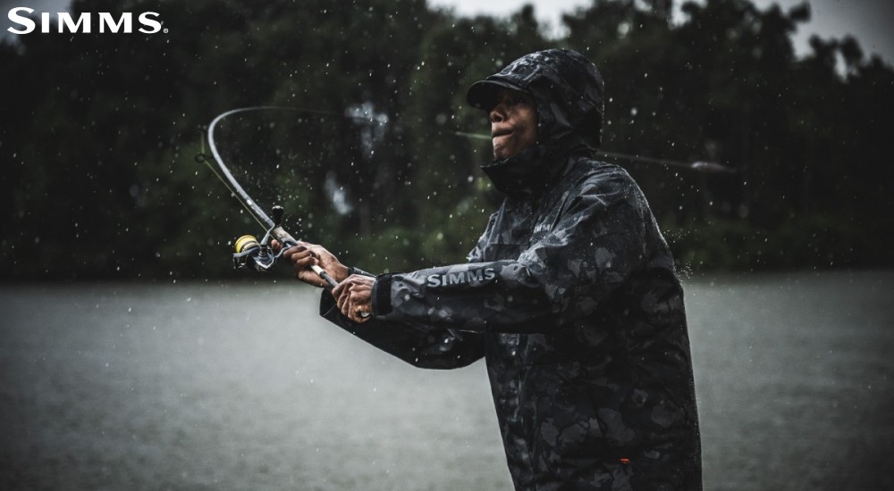 a fisherman wearing a rain jacket on the water