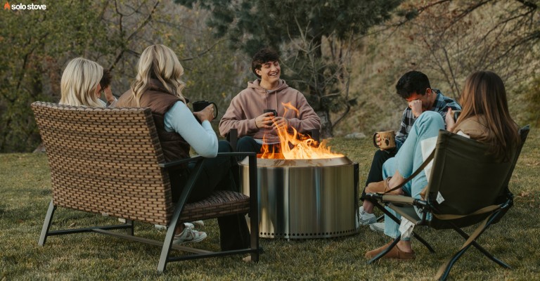 a group of people around the canyon solo stove